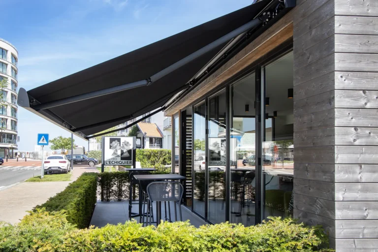 B35-Gelenkarmmarkise von Brustor als Sonnenschutz für eine Café-Terrasse